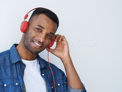 Buy stock photo Man, smile and headphones in studio portrait by mockup space, streaming or subscription by white background. African person, happy and audio tech for music, listening and sound with internet radio