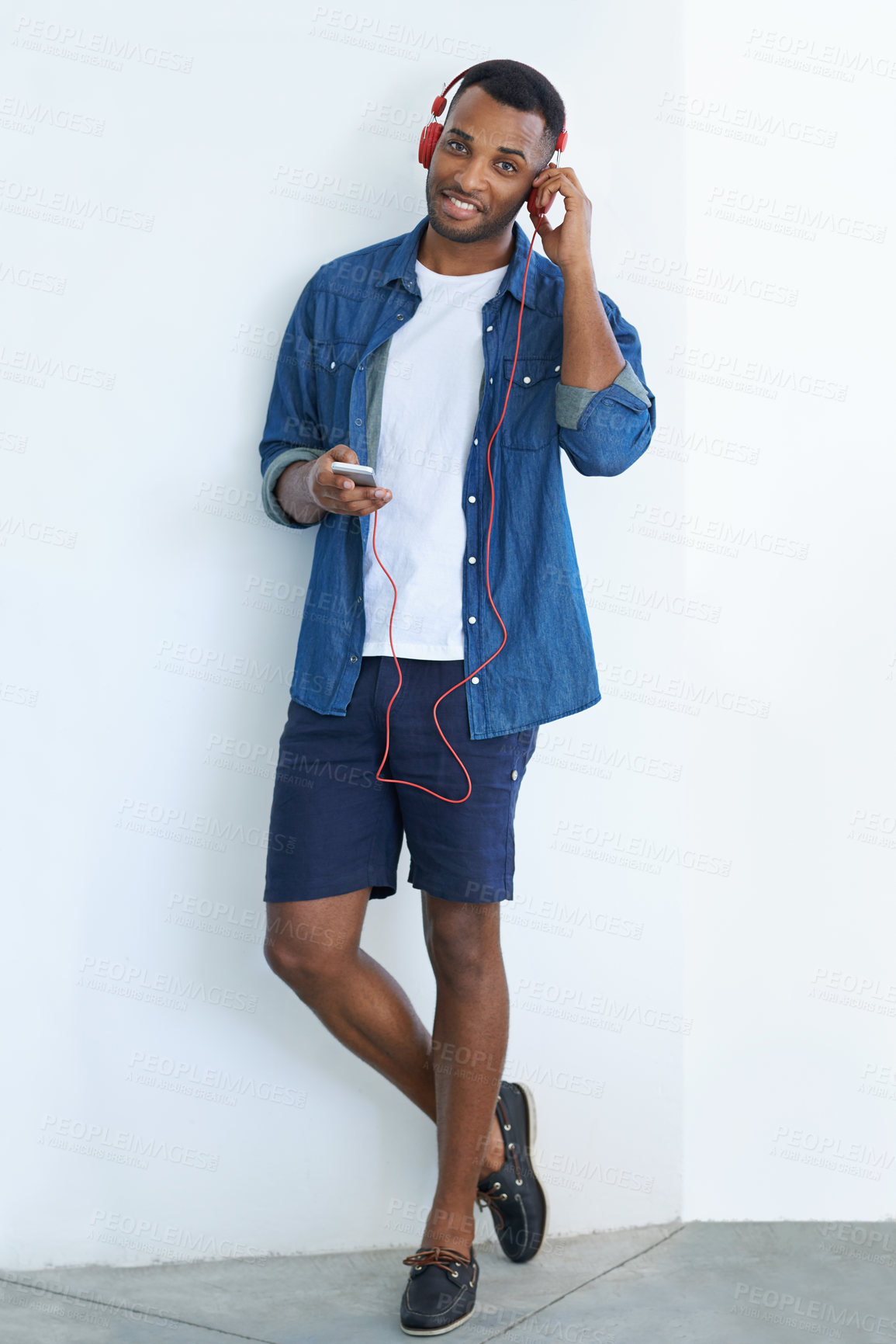 Buy stock photo A young african american man wearing a headphones and listening to music against a white background 