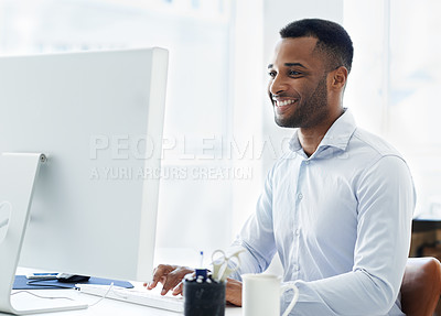 Buy stock photo A handsome young african american businessman working at his desk