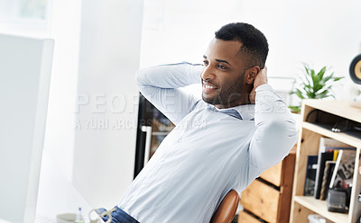 Buy stock photo A handsome young african american businessman sitting at his desk and relaxing