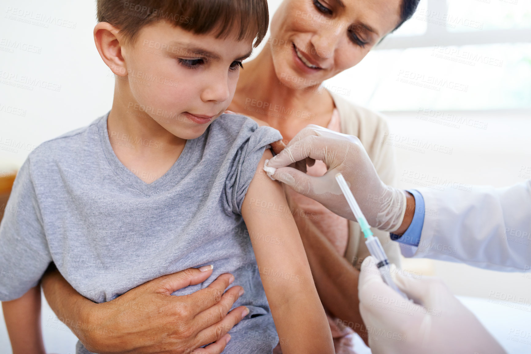 Buy stock photo Closeup shot of a young boy receiving an injection