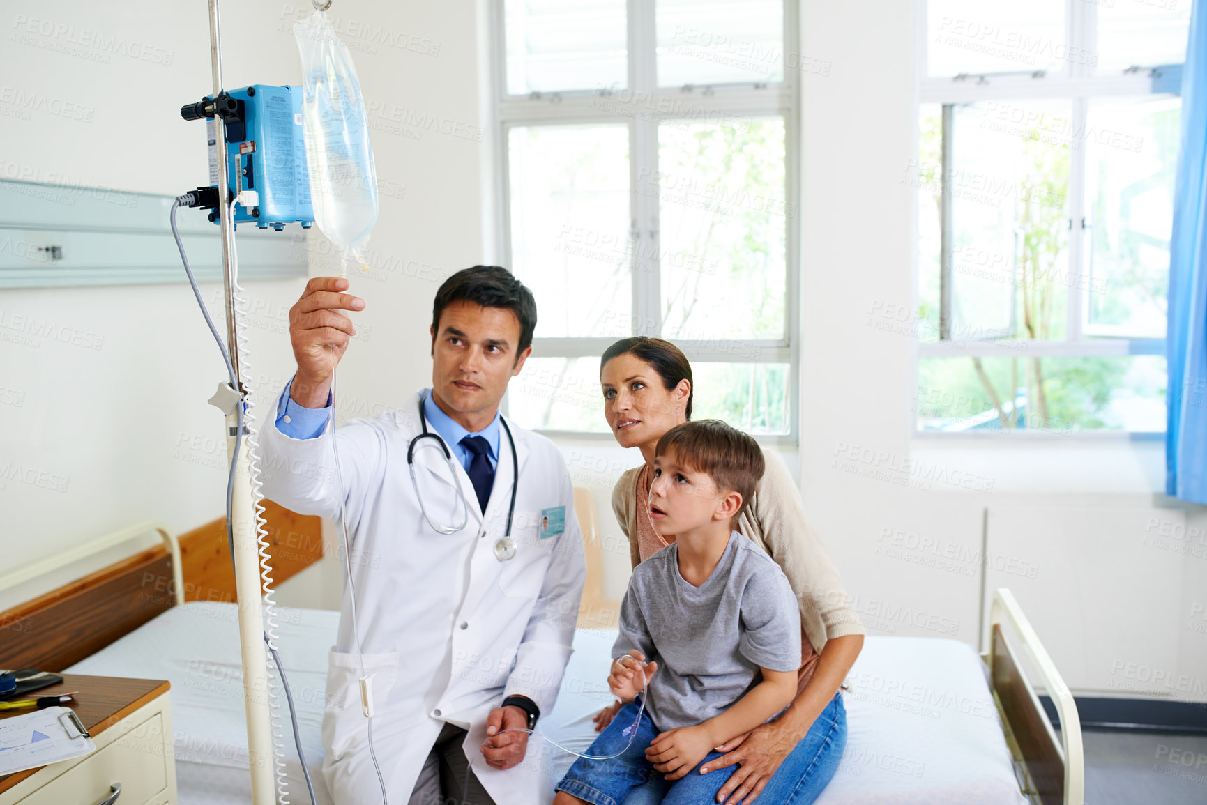 Buy stock photo IV drip, medical or smile with doctor and family in hospital together for appointment, checkup or vaccine. Consulting, healthcare or solution with mother, son and pediatrician in wellness clinic