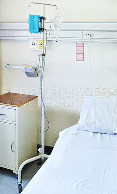 Buy stock photo Interior shot of a bed and an IV stand in a hospital ward