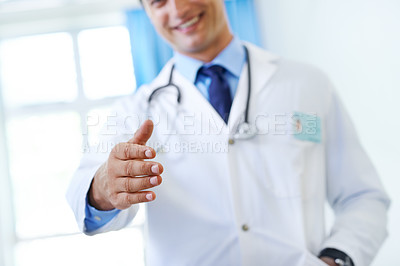Buy stock photo Closeup shot of a doctor extending his hand in greeting