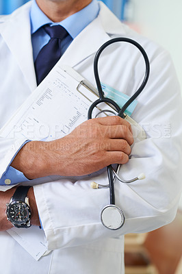 Buy stock photo Closeup shot of a doctor holding a patient chart and a stethoscope