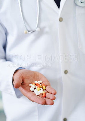 Buy stock photo Closeup of a doctor's hand holding a pile of different types of medication