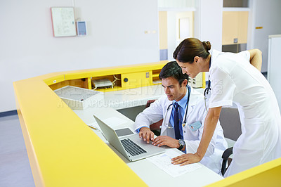 Buy stock photo Doctor, nurse and front desk in clinic on laptop, discussion and planning for patient schedule in hospital. Medical employees, healthcare service and people together, teamwork and professional