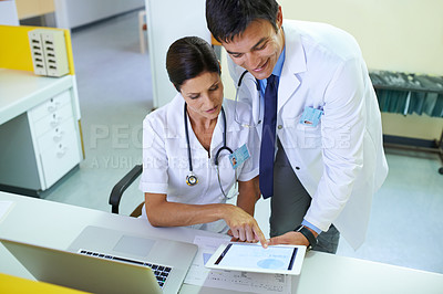 Buy stock photo Shot of a medical team going through a patient's chart