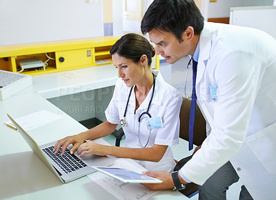 Buy stock photo Shot of a medical team doing research online