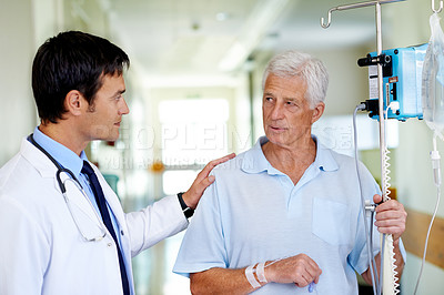 Buy stock photo Hospital, talking and doctor with old man, walking and elderly person with serious for medical appointment. Clinic, IV drip and nutrition for wellness, hydration and listen for healthcare and work