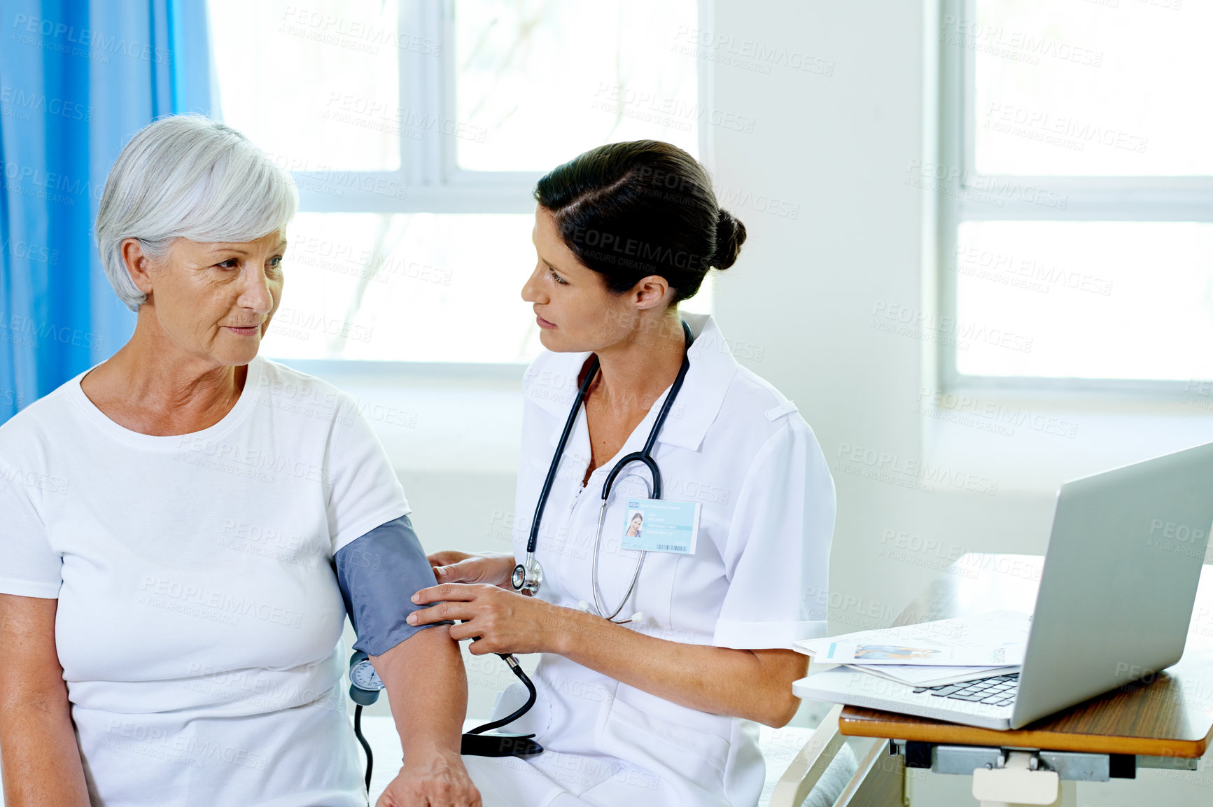 Buy stock photo Nurse, mature and patient in hospital for blood pressure, routine check up and health management for condition. Elderly woman, medical worker and hypertension assessment for evaluation or prevention.