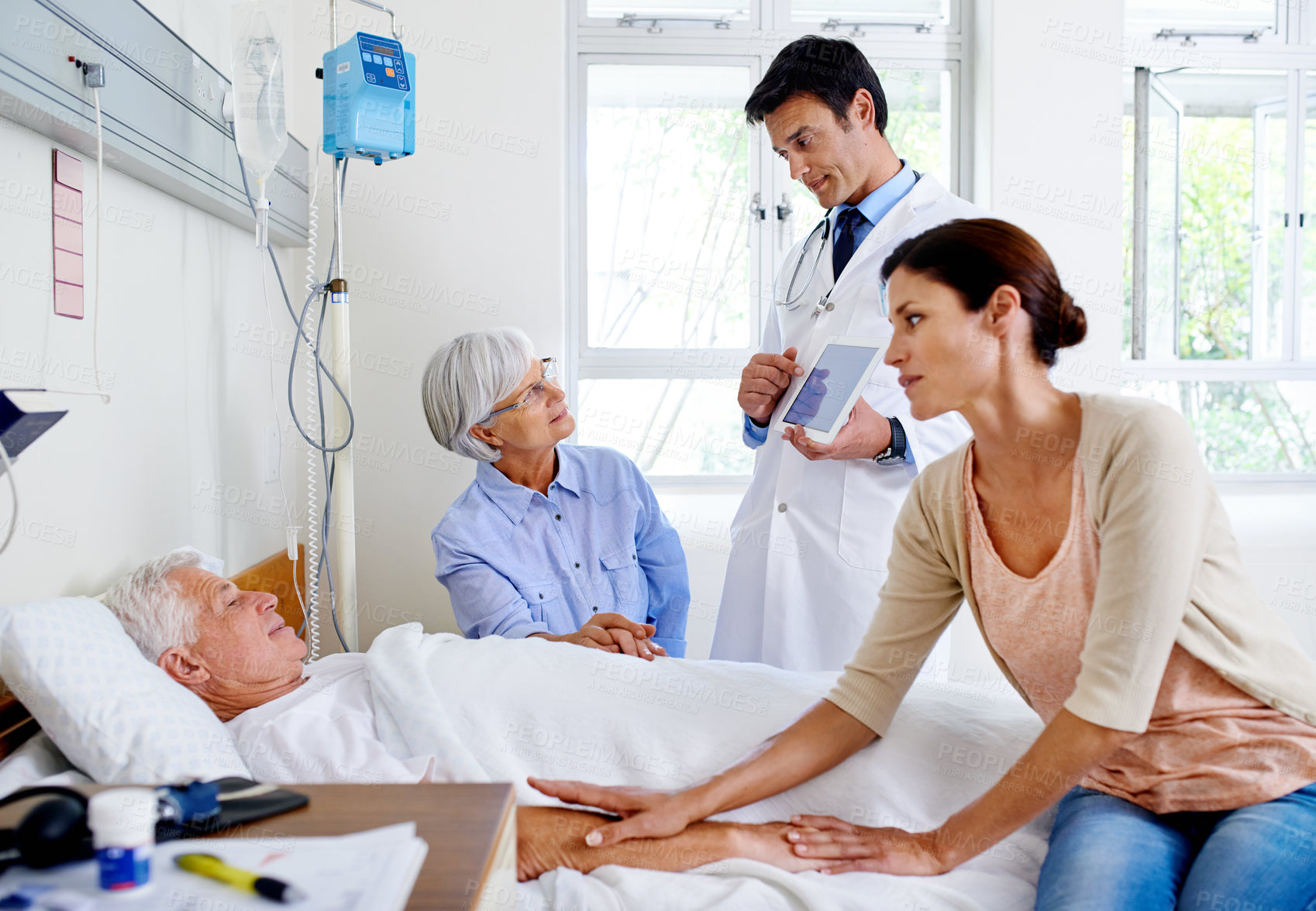 Buy stock photo Tablet, doctor or patient with family support in clinic for news, medicine or medical results. People, sick father or old man holding hands for healthcare, visit and senior treatment in hospital bed