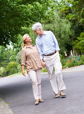 Buy stock photo Shot of an affectionate senior couple talking a walk