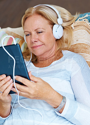 Buy stock photo Tablet, online and senior woman on patio, happy and headphones for movies, thinking and relax in retirement. Watch, app and old person with subscription of film, smile and grandma with peace in home