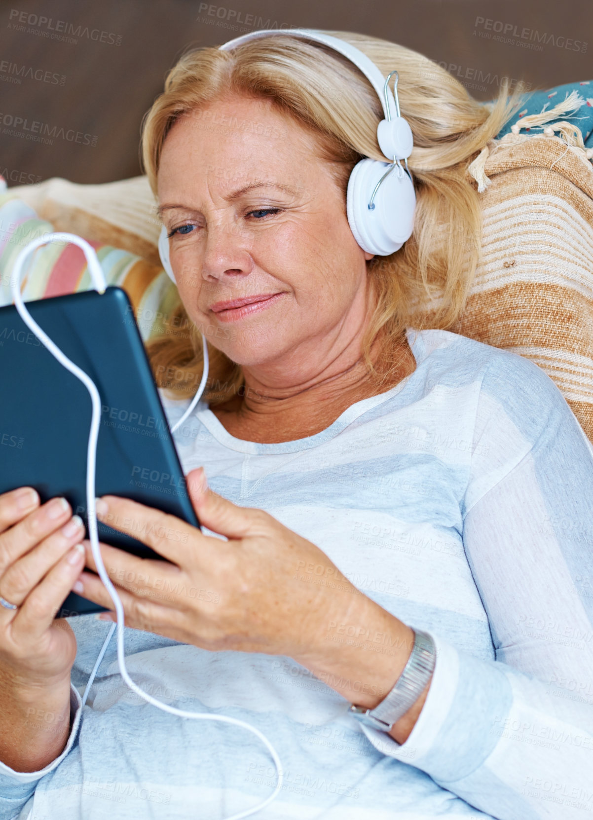 Buy stock photo Tablet, online and senior woman on patio, happy and headphones for movies, thinking and relax in retirement. Watch, app and old person with subscription of film, smile and grandma with peace in home