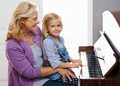 Buy stock photo Piano, family and learning in home for music, development and portrait or practice in lounge. Keys, creativity and girl or grandma in house with string instrument for sound, talent and audio for art