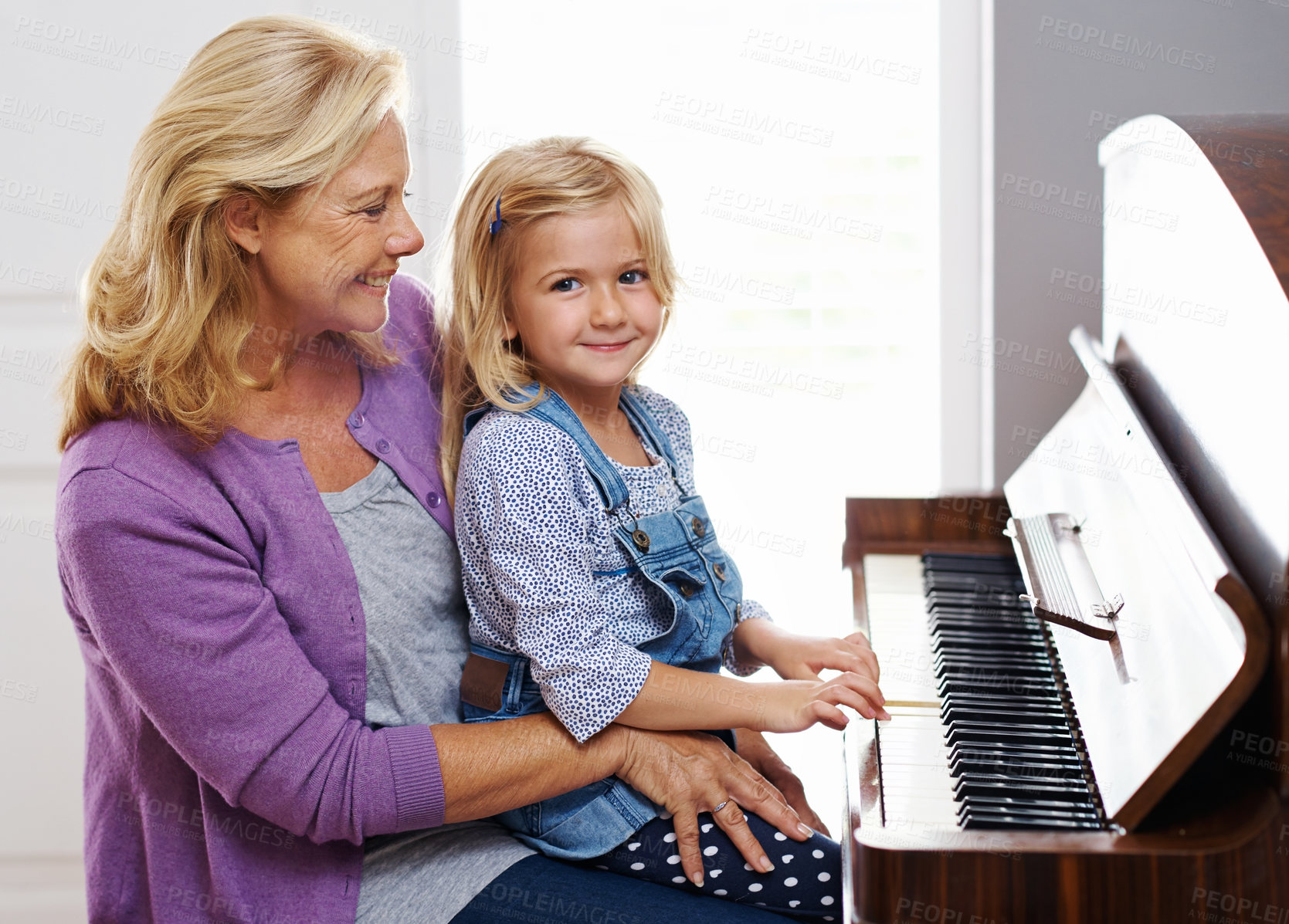 Buy stock photo Piano, family and learning in home for music, development and portrait or practice in lounge. Keys, creativity and girl or grandma in house with string instrument for sound, talent and audio for art