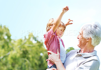 Buy stock photo Shot of a happy grandfather holding his young grandson