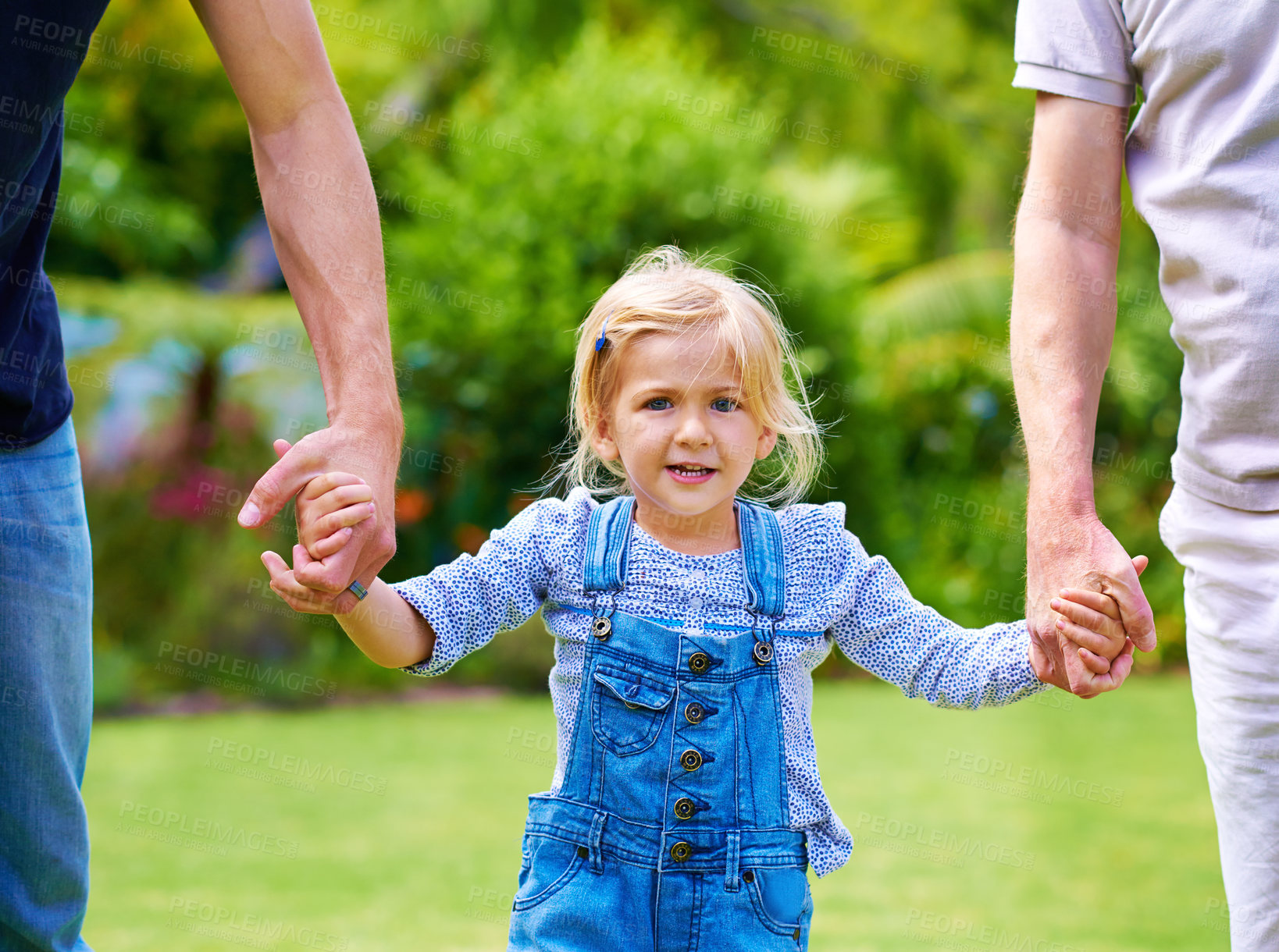 Buy stock photo Holding hands, parents or child in garden for portrait, love or bonding together for walking or care. Mother, happy girl or father in nature for support or playing with smile, growth or playful kid