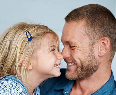 Buy stock photo Shot of an adorable little girl rubbing noses with her father