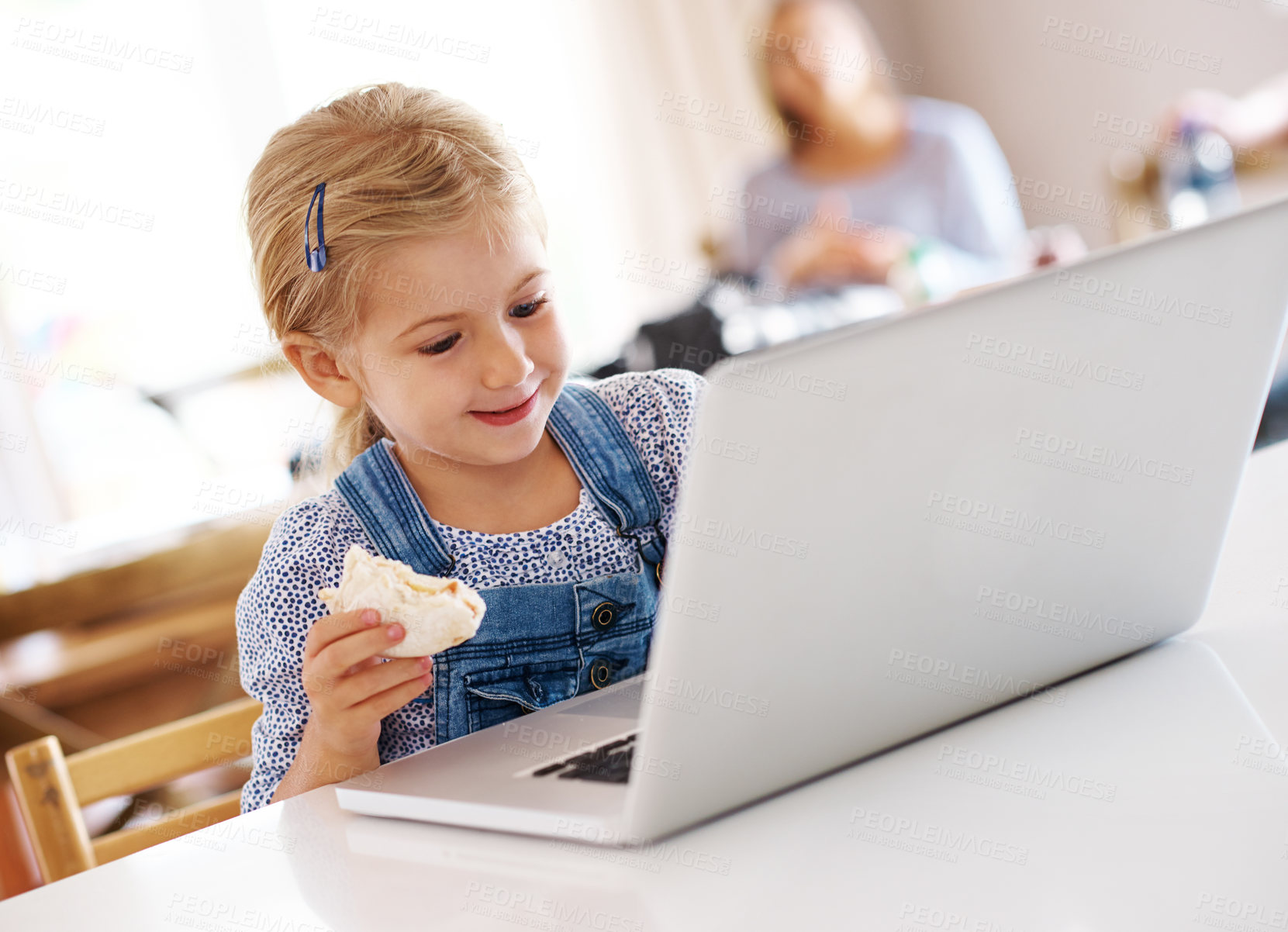 Buy stock photo Child, laptop and typing in kitchen for education, online and internet for e learning at table. Kid, snack and smile for social media in home and streaming with digital app or website for networking