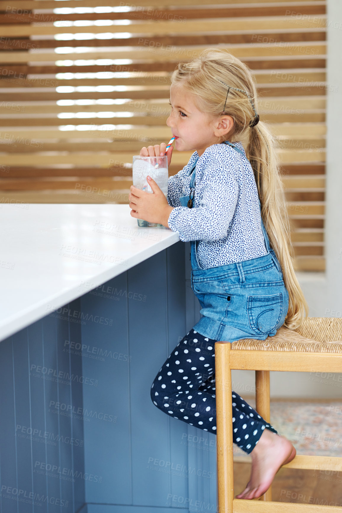 Buy stock photo Girl, child and milk in home, nutrition and vitamin liquid for growth development. Female person, kid and glass of mineral juice for calcium at kitchen table, dairy breakfast and support function