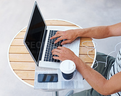 Buy stock photo High angle shot of a man working on a laptop outside