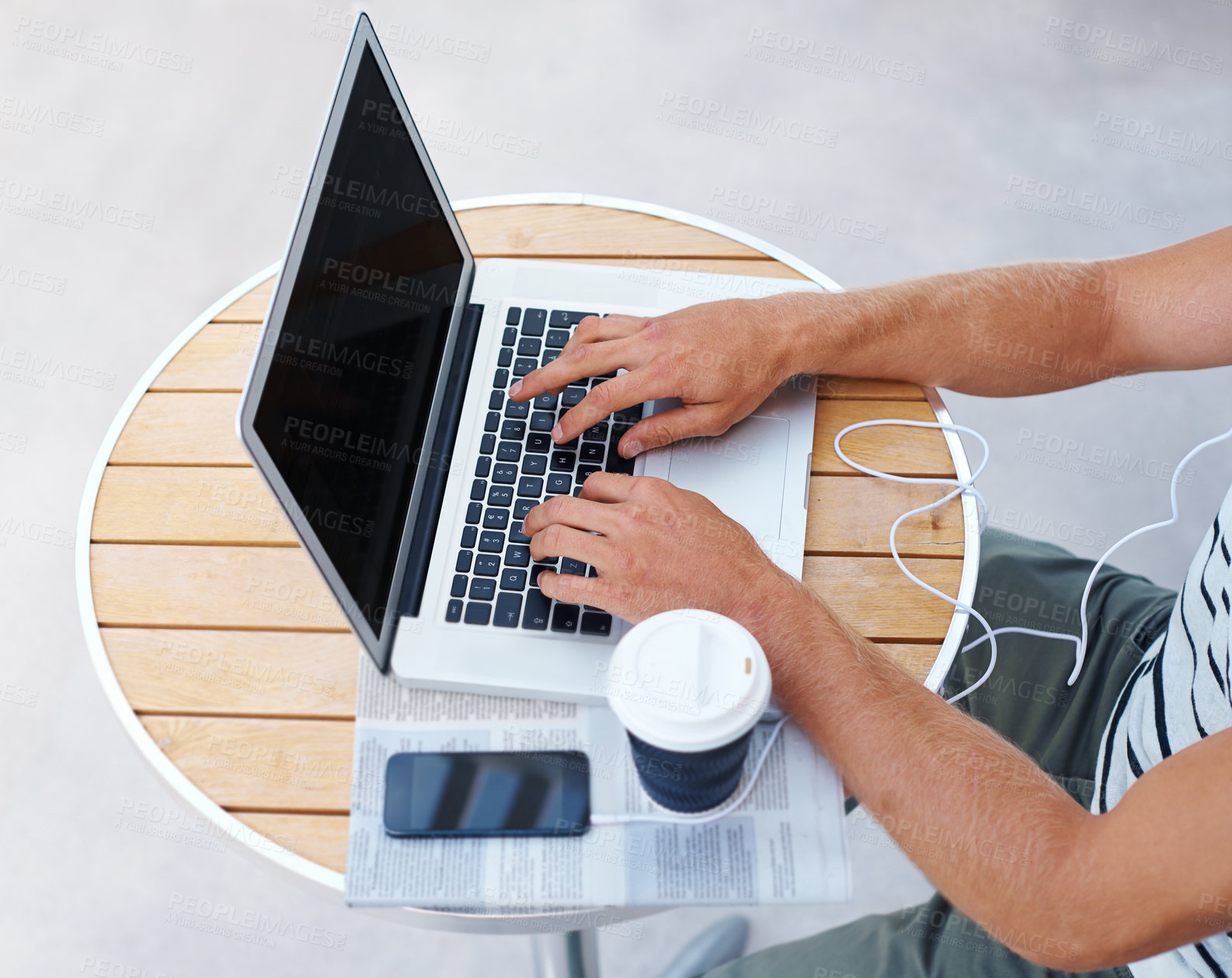 Buy stock photo High angle shot of a man working on a laptop outside