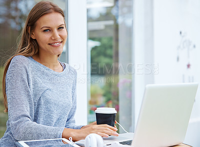 Buy stock photo Portrait of an attractive young woman working on a laptop outside a cafe