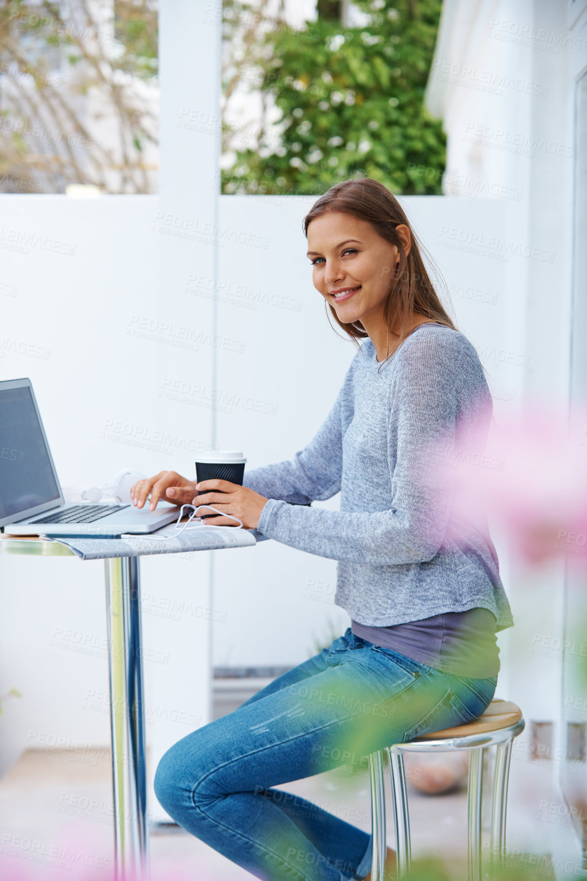 Buy stock photo Portrait of an attractive young woman working on a laptop outside a cafe