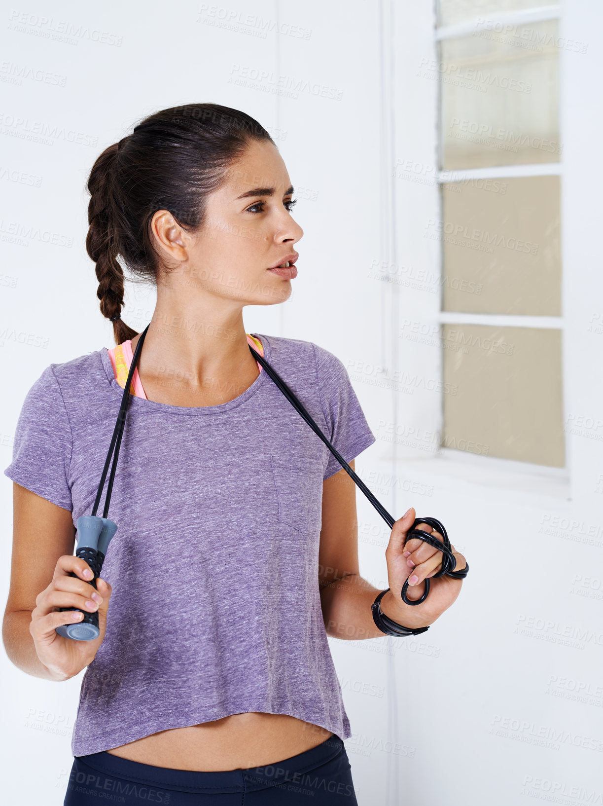 Buy stock photo Woman, fitness and serious with skipping rope for workout at home with confidence for self care. Female person, portrait and think on exercise, training and warm up for health, wellbeing and wellness