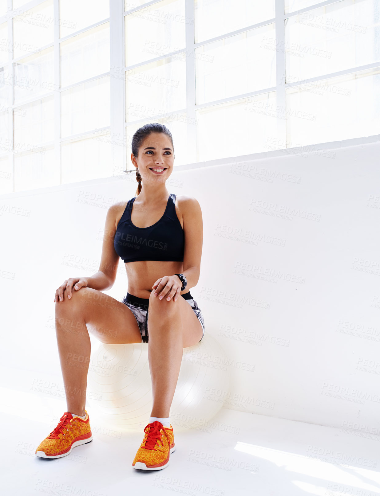 Buy stock photo Studio shot of an attractive young woman working out