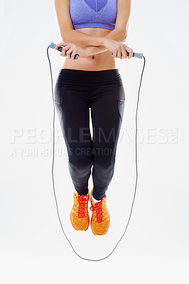 Buy stock photo Woman, fitness and air with jump rope for workout, exercise or training on a white studio background. Active female person or athlete with string or wire for skipping, endurance or cardio practice