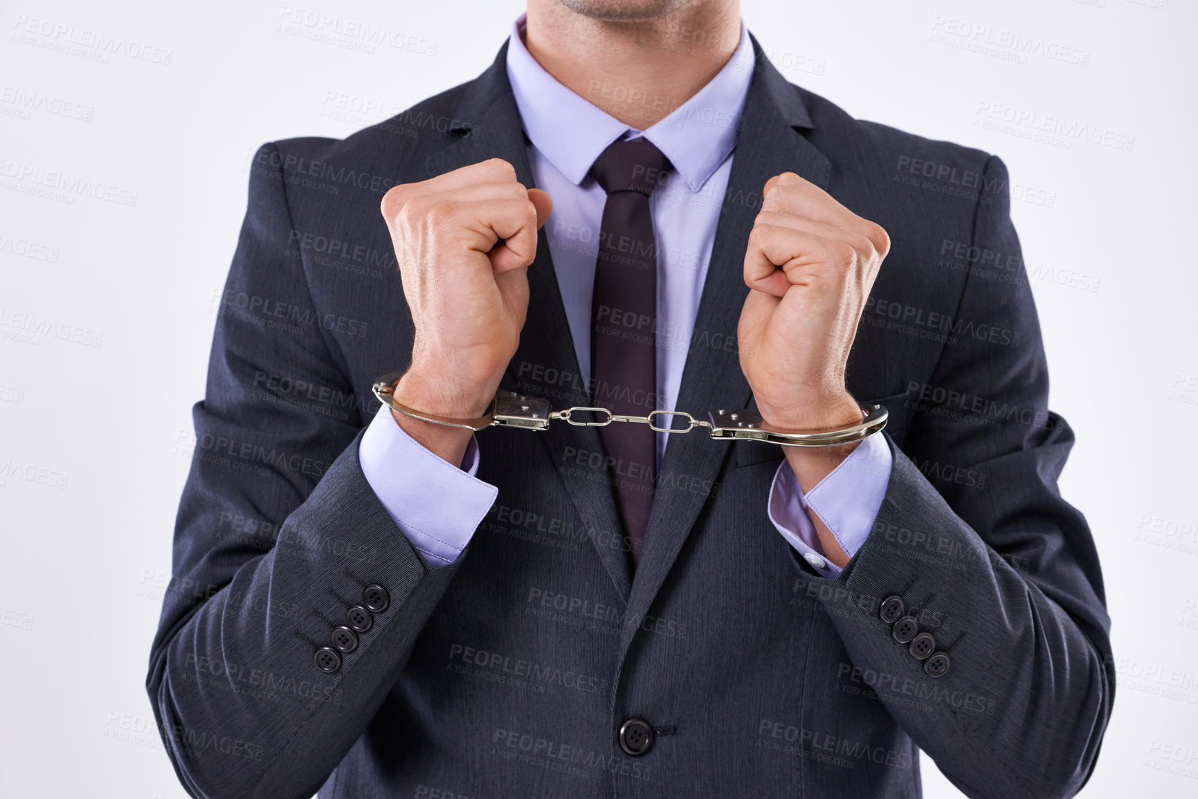 Buy stock photo Cropped studio shot of a businessman in handcuffs