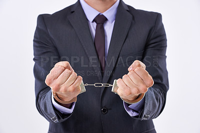 Buy stock photo Cropped studio shot of a businessman in handcuffs