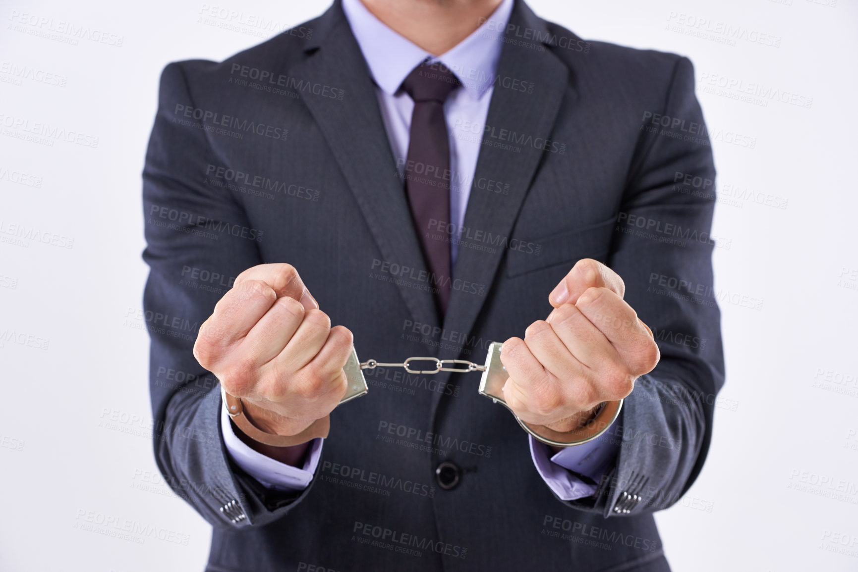 Buy stock photo Cropped studio shot of a businessman in handcuffs