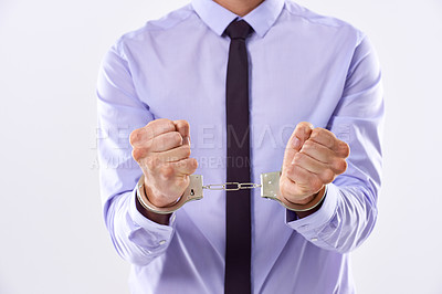 Buy stock photo Business, man and handcuffs in studio in white background for arrest or trapped in corporate affairs. Male person, entrepreneur and guilty as criminal for financial crime, fraud and corruption