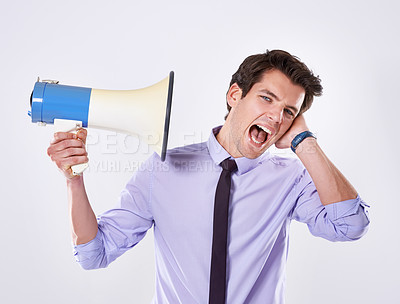 Buy stock photo Business man, loud and megaphone by ear in studio for communication, announcement or breaking news. Employee, noise and loudspeaker on white background for broadcast, warning and corporate propaganda