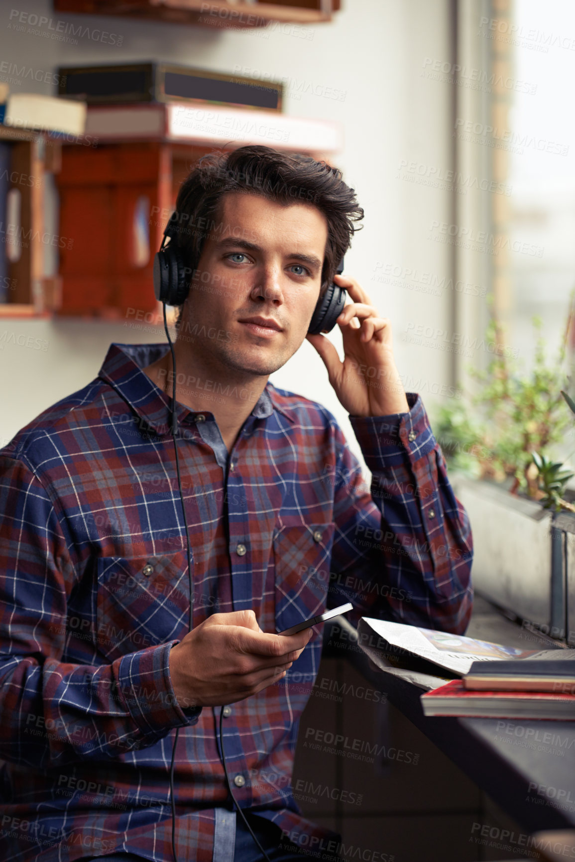 Buy stock photo Portrait, headphones and man in cafe with phone for social media, subscription notification or streaming music. Male student, books or mobile for learning with online network, happy for study app
