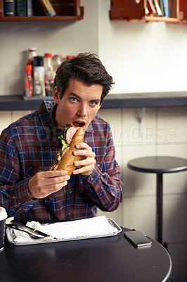 Buy stock photo Lunch, portrait and sandwich with man at restaurant for meal, nutrition and eating. Shocked, face and expression of creative designer employee in cafe or coffee shop for surprise, food and hunger