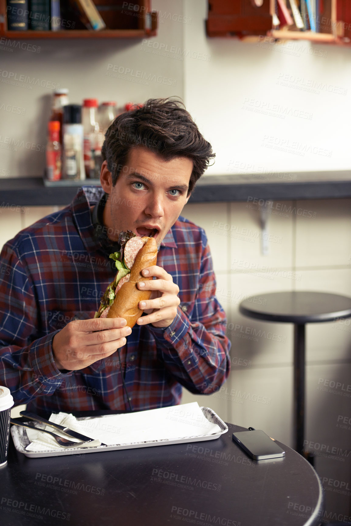 Buy stock photo Lunch, portrait and sandwich with man at restaurant for meal, nutrition and eating. Shocked, face and expression of creative designer employee in cafe or coffee shop for surprise, food and hunger