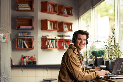 Buy stock photo Student, portrait or happy man in cafe on laptop for course, college research or music streaming platform. Learning, headphones or typing on technology with online network, connection or studying app