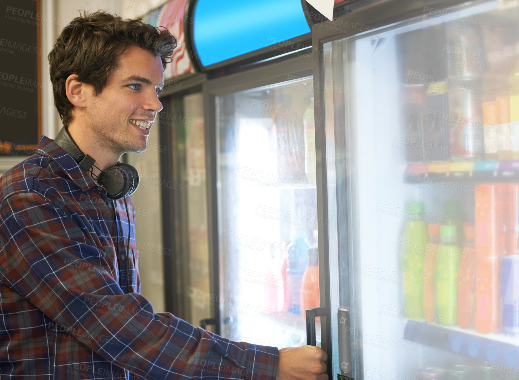 Buy stock photo Man, fridge and grocery for soda, drinks and deal with headphones, smile and excited in supermarket. Student, refrigerator and choice for decision, purchase and price in convenience store as customer