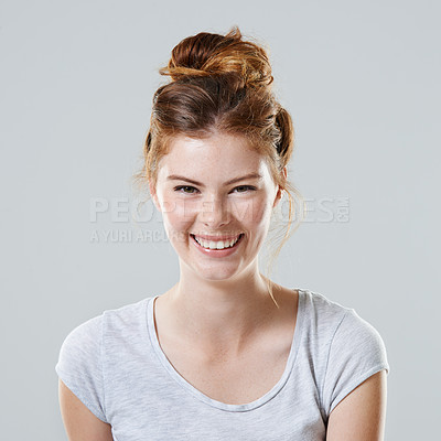 Buy stock photo Cropped studio portrait of a beautiful young woman against a gray background