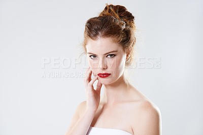 Buy stock photo Cropped studio portrait of a beautiful young woman with bare shoulders isolated on gray