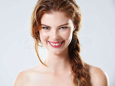 Buy stock photo Studio portrait of a beautiful young woman with braided hair standing against a gray background