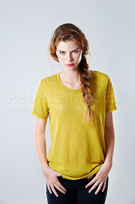Buy stock photo Cropped studio portrait of a gorgeous young woman standing against a gray background