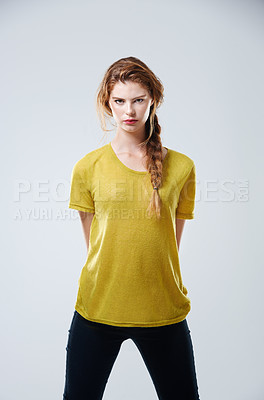 Buy stock photo Serious, student and portrait for fashion in studio with tshirt, trendy outfit and natural beauty of cosmetic glow. Girl, stretching and casual clothes for style, makeup and pride on white background