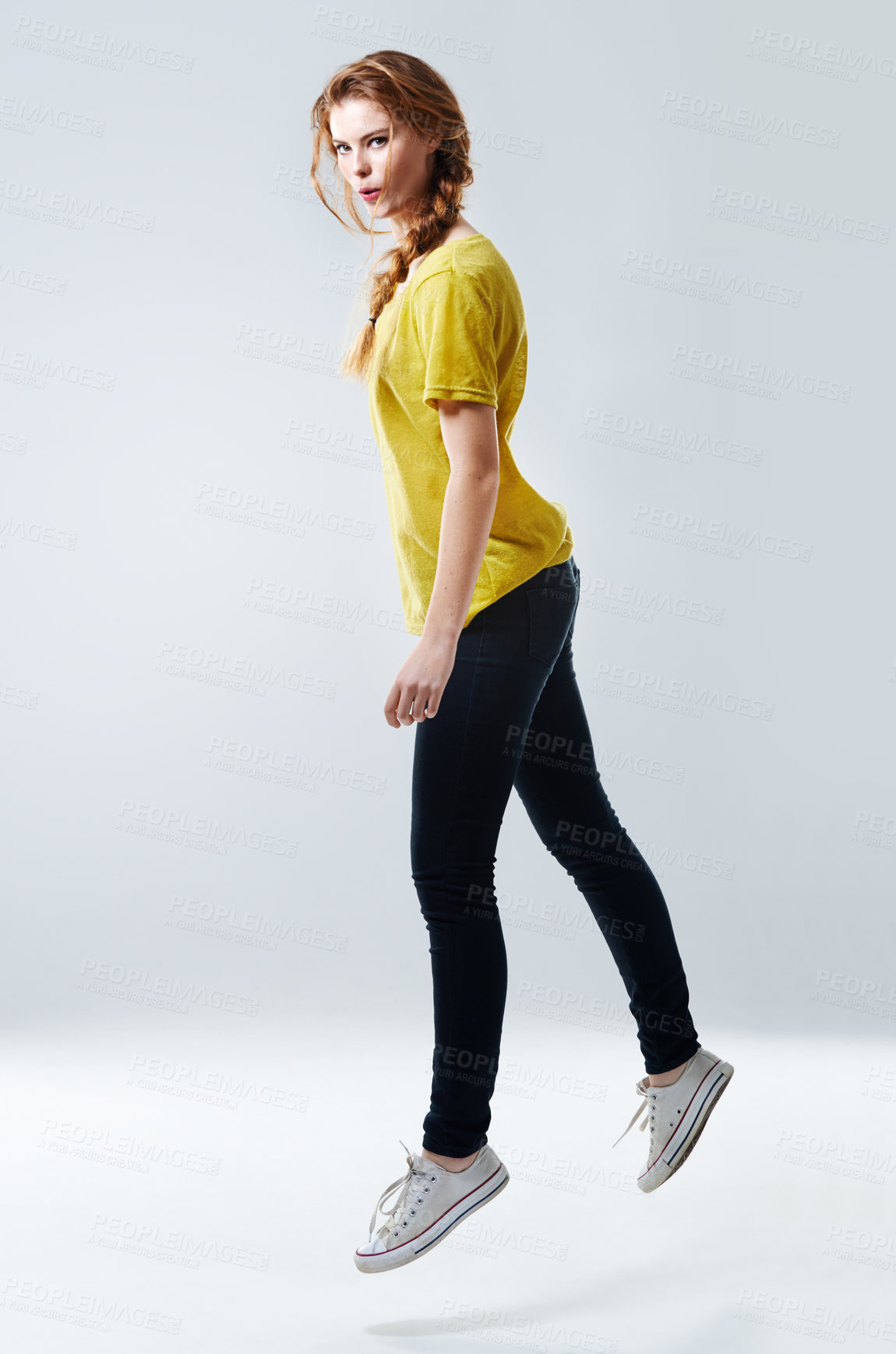 Buy stock photo Portrait, girl and fashion with confidence, street wear and jumping in air on white background. Female person, style and trendy in studio backdrop, satisfied and casual in outfit, clothes and pride