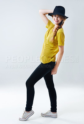 Buy stock photo Portrait, fashion and woman with smile, hat and happiness on gray studio background. Face, hipster and person with casual outfit, cheerful and confidence with pride, stylish clothes and sneakers